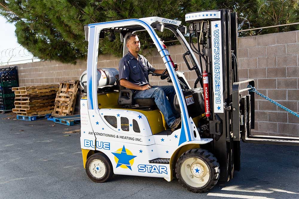 Little Joe, Blue Star's star-decorated Yale forklift, driven across the yard by a Blue Star team member