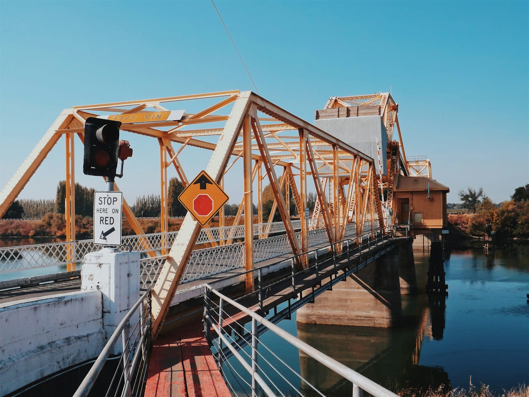 Orange steel truss drawbridge crossing the Sacramento River at Courtland in the Delta