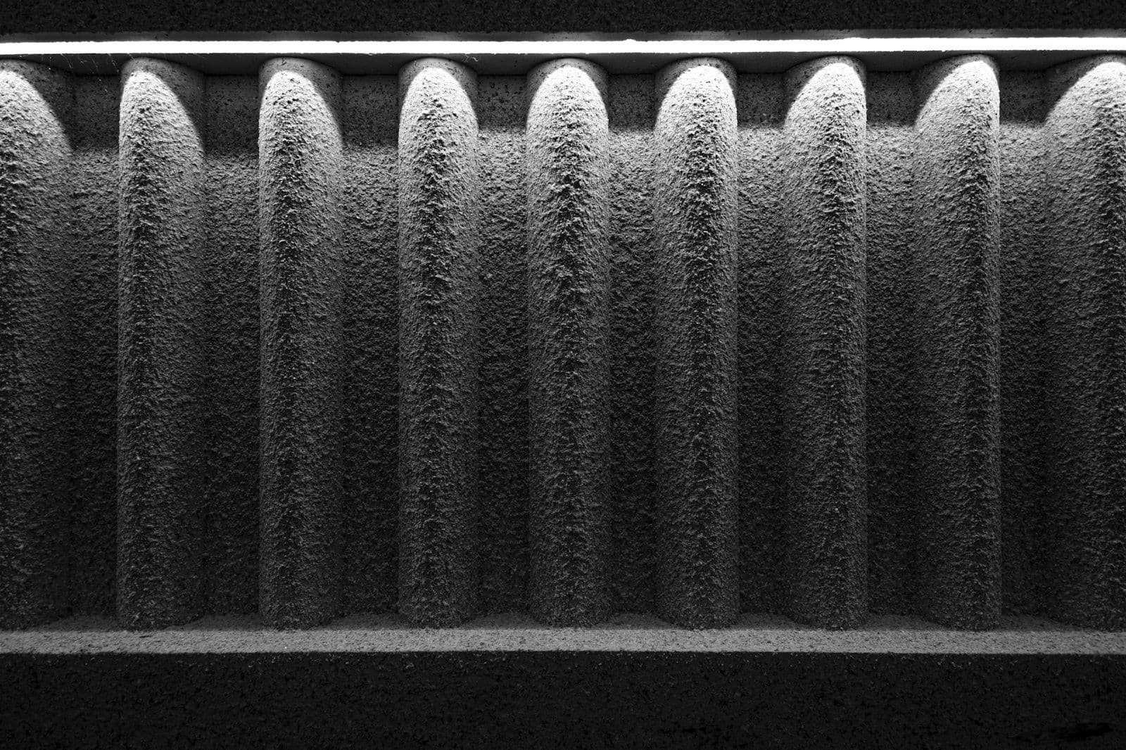 Black-and-white close-up of a dust-clogged pleated air filter