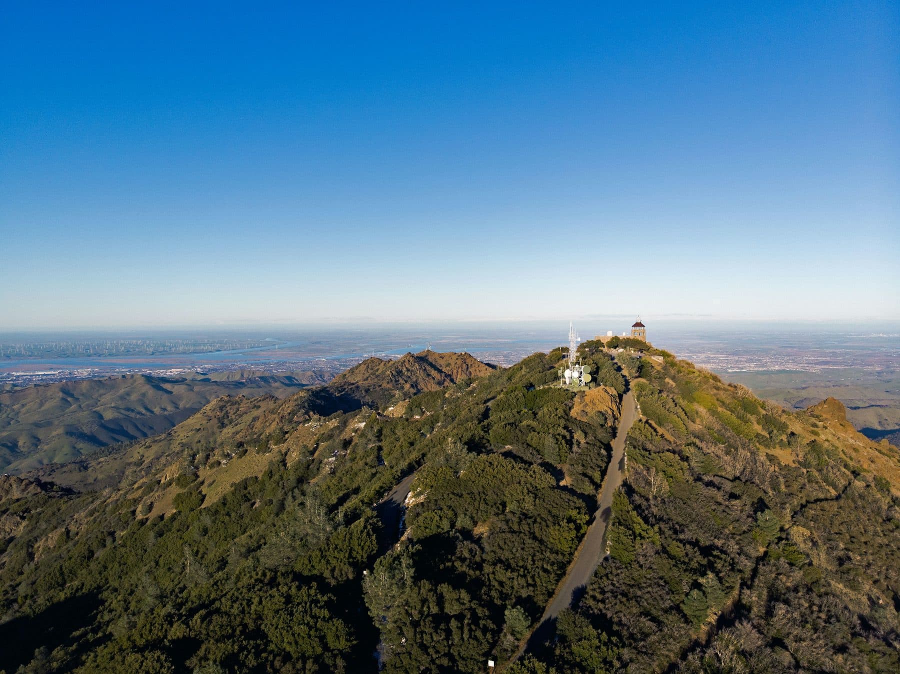 Aerial view of Mount Diablo's summit and its summit buildings above chaparral-covered ridges