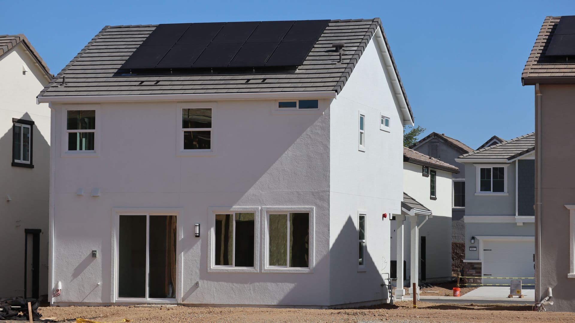 New two-story stucco home with rooftop solar panels in Elk Grove, California
